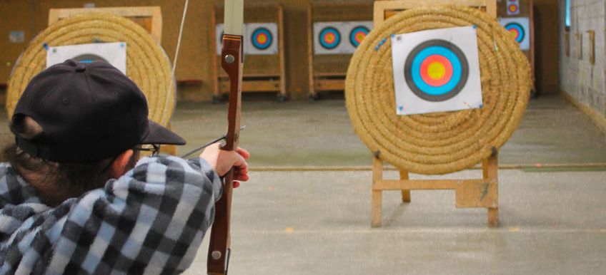 personne en fauteuil roulant pratiquant du tir à l'arc